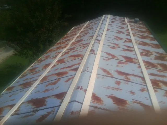 Rusted metal roof panels with new wood purlins before replacement — Storm Damage Roof Repair in Armonk by Roofing Brothers